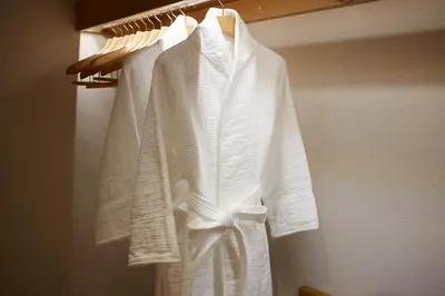 a group of white clothes hanging on a rack at Keio Plaza Hotel Tokyo Premier Grand in Tokyo