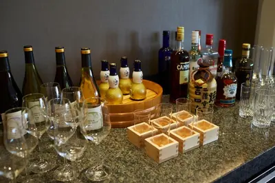 a bunch of wine glasses and wine bottles on a counter at Keio Plaza Hotel Tokyo Premier Grand in Tokyo
