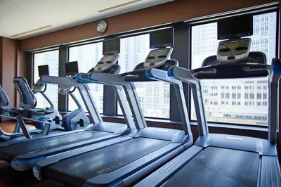 a gym with several treadmills in front of windows at Keio Plaza Hotel Tokyo Premier Grand in Tokyo