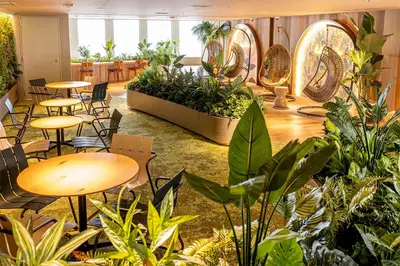 a room with tables and chairs and plants at Keio Plaza Hotel Tokyo Premier Grand in Tokyo