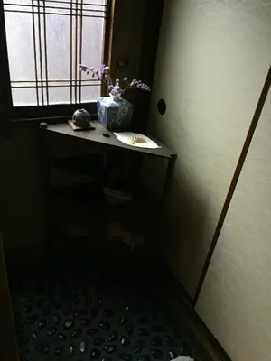 a small bathroom with a table and a window at Tama Ryokan in Tokyo