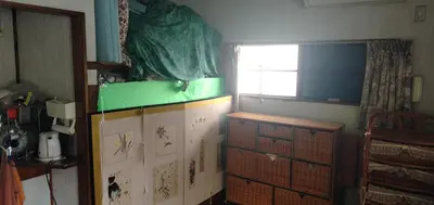 a kitchen with a green counter top and wooden cabinets at Tama Ryokan in Tokyo