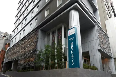 a building with a sign in front of it at Sotetsu Fresa Inn Tokyo Roppongi in Tokyo