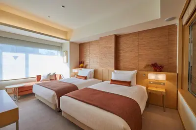 a hotel room with two beds and a window at THE KITANO HOTEL TOKYO in Tokyo