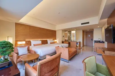 a hotel room with a bed and tables and chairs at THE KITANO HOTEL TOKYO in Tokyo