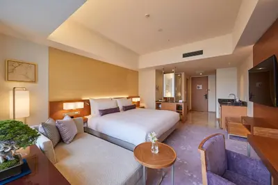 a hotel room with a bed and a living room at THE KITANO HOTEL TOKYO in Tokyo