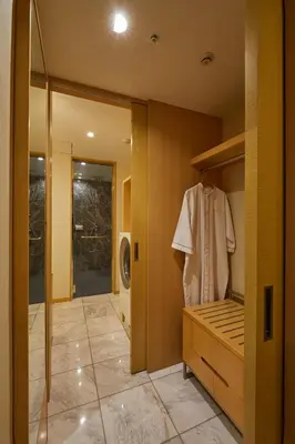 a walk in closet with a robe on a hanger at THE KITANO HOTEL TOKYO in Tokyo