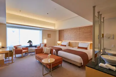 a hotel room with two beds and a bathroom at THE KITANO HOTEL TOKYO in Tokyo