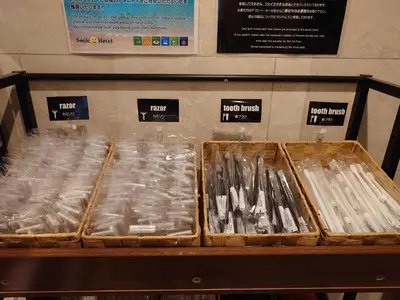 three trays of packaged items on a shelf in a store at Smile Hotel Tokyo Shinkoiwa in Tokyo
