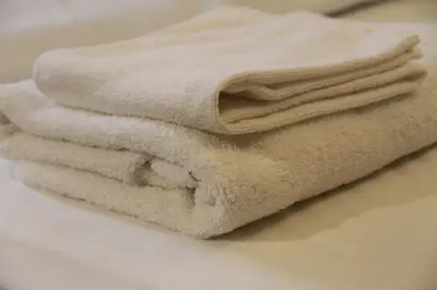 a pile of towels sitting on top of a counter at Smile Hotel Tokyo Shinkoiwa in Tokyo