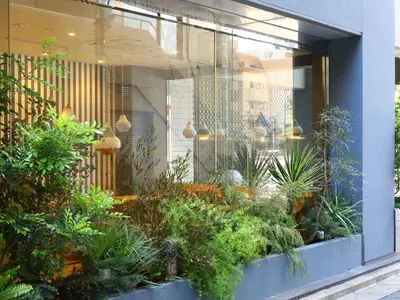 a store window with a bunch of plants at KOKO HOTEL Ikebukuro East - formerly Hotel Wing International Ikebukuro in Tokyo