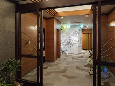 an office corridor with a glass door and plants at KOKO HOTEL Ikebukuro East - formerly Hotel Wing International Ikebukuro in Tokyo