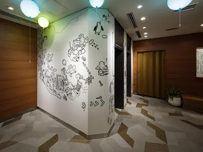 a lobby with a wall with writing on it at KOKO HOTEL Ikebukuro East - formerly Hotel Wing International Ikebukuro in Tokyo