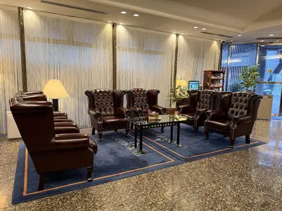 a waiting room with leather chairs and a table at Shibuya Creston Hotel in Tokyo