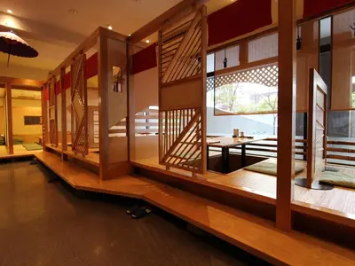 a room with a row of windows and tables at Shibuya Creston Hotel in Tokyo