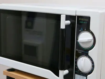 a microwave oven with two mirrors on top of it at KOKO HOTEL Korakuen - formerly Hotel Wing International Korakuen in Tokyo