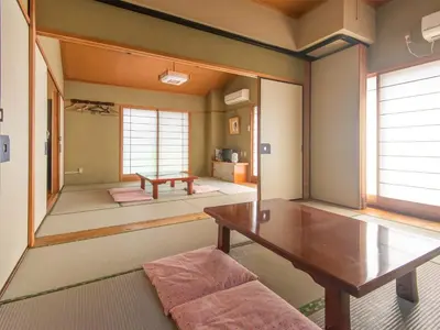 a living room with a table and a couch at Sakura Ryokan Asakusa Iriya in Tokyo