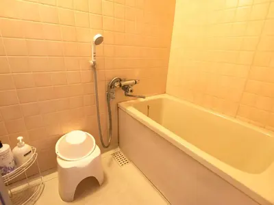 a bathroom with a bath tub and a toilet at Sakura Ryokan Asakusa Iriya in Tokyo