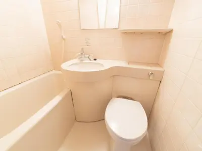 a bathroom with a toilet and a sink and a tub at Sakura Ryokan Asakusa Iriya in Tokyo