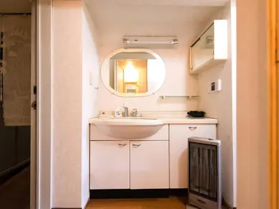 a bathroom with a sink and a mirror at Sakura Ryokan Asakusa Iriya in Tokyo