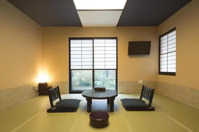 a living room with a table and two chairs at Guest House Wagokoro in Tokyo
