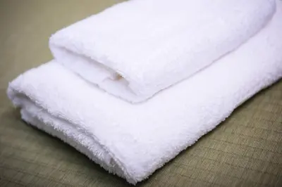 a stack of white towels sitting on a table at Guest House Wagokoro in Tokyo