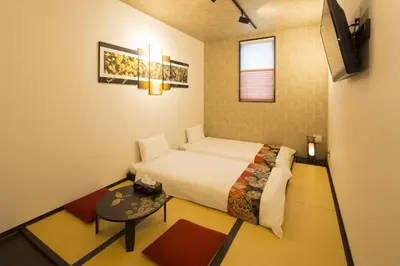 a small bedroom with a bed and a table at Guest House Wagokoro in Tokyo