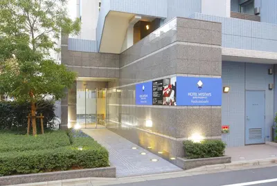 a building with a sign on the side of it at HOTEL MYSTAYS Asakusabashi in Tokyo