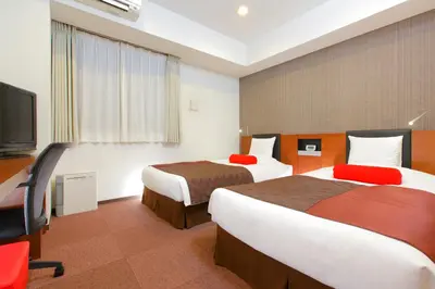 a hotel room with two beds and a flat screen tv at HOTEL MYSTAYS Asakusabashi in Tokyo