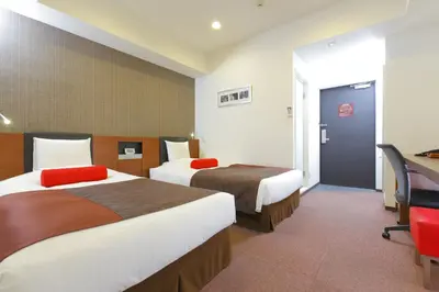 a hotel room with two beds and a desk at HOTEL MYSTAYS Asakusabashi in Tokyo