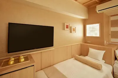 a room with a flat screen tv on the wall at HOTEL MYSTAYS Asakusabashi in Tokyo