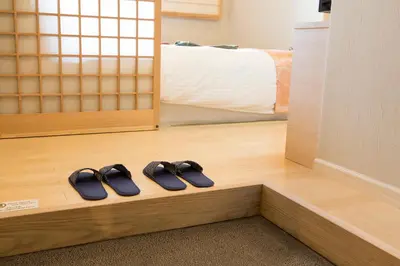 two pairs of slippers sitting on a shelf in a room at HOTEL MYSTAYS Asakusabashi in Tokyo