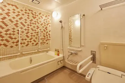 a bathroom with a tub and a toilet and a sink at HOTEL MYSTAYS Asakusabashi in Tokyo