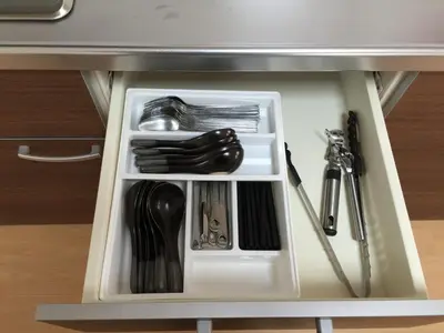 a drawer in a table with some utensils at Issyuku hostel in Tokyo