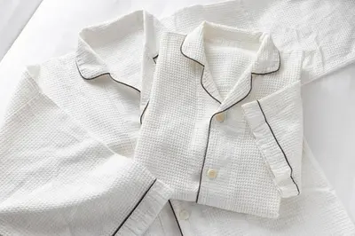 a white shirt and tie sitting on a table at Tokyu Stay Ikebukuro in Tokyo