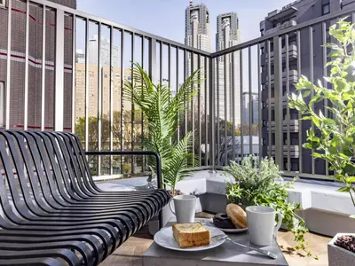 a balcony with a bench and a table with food on it at Tokyu Stay Nishi Shinjuku in Tokyo