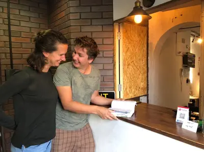 two women are standing next to a counter at Tokyo Guest House Ouji Music Lounge in Tokyo