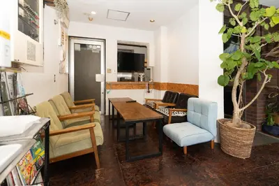 a living room with a table and chairs at Tokyo Guest House Ouji Music Lounge in Tokyo