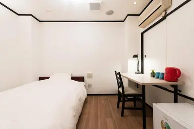 a bedroom with a bed and a desk and a table at Tokyo Guest House Ouji Music Lounge in Tokyo