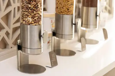 two coffee grinders sitting on a counter with nuts at Tokyu Stay Aoyama Premier in Tokyo