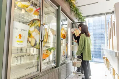 people looking at food in a display case in a store at Tokyu Stay Aoyama Premier in Tokyo