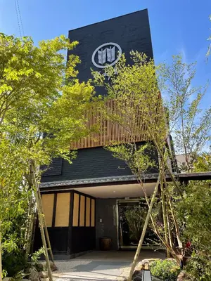a building with a sign on the top of it at Hotel Fukudaya in Tokyo