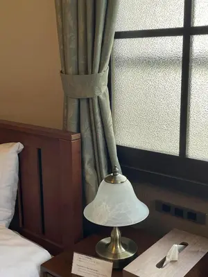 a lamp sitting on a table next to a window at Hotel Fukudaya in Tokyo