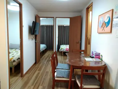 a room with a table and a room with a bedroom at Rimon Apartment in Tokyo