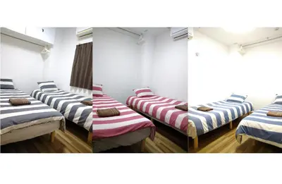 a row of beds in a room at Rimon Apartment in Tokyo