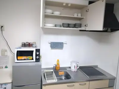 a small kitchen with a sink and a microwave at Rimon Apartment in Tokyo
