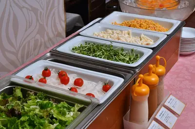 a buffet with several trays of food on a table at Hotel Listel Shinjuku in Tokyo