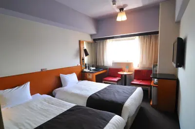 a hotel room with two beds and a television at Hotel Listel Shinjuku in Tokyo