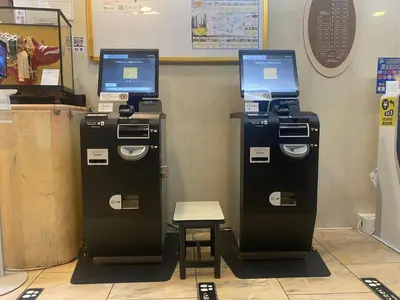 two atm machines in a store with a stool at Hotel Listel Shinjuku in Tokyo