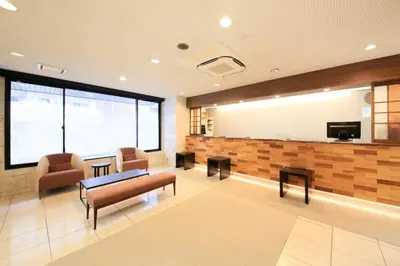 a waiting room with a table and chairs at Smile Hotel Tokyo Ayase Ekimae in Tokyo